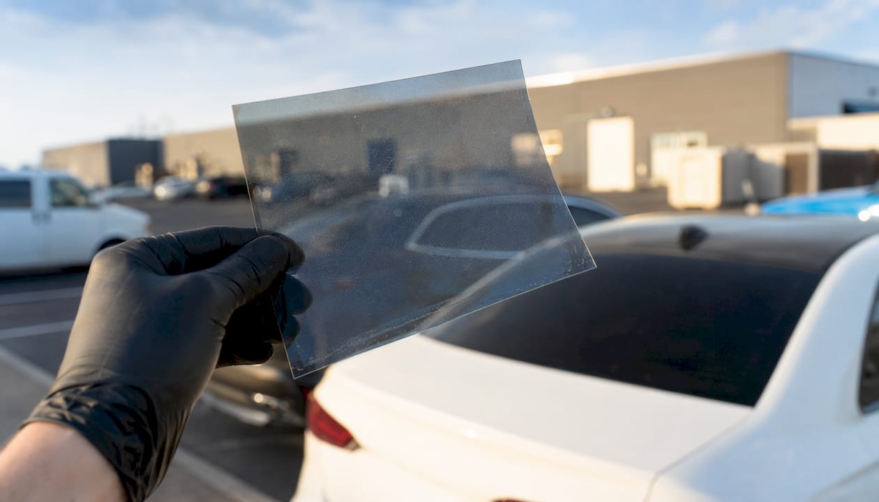 Close-up of ceramic tint film with hand