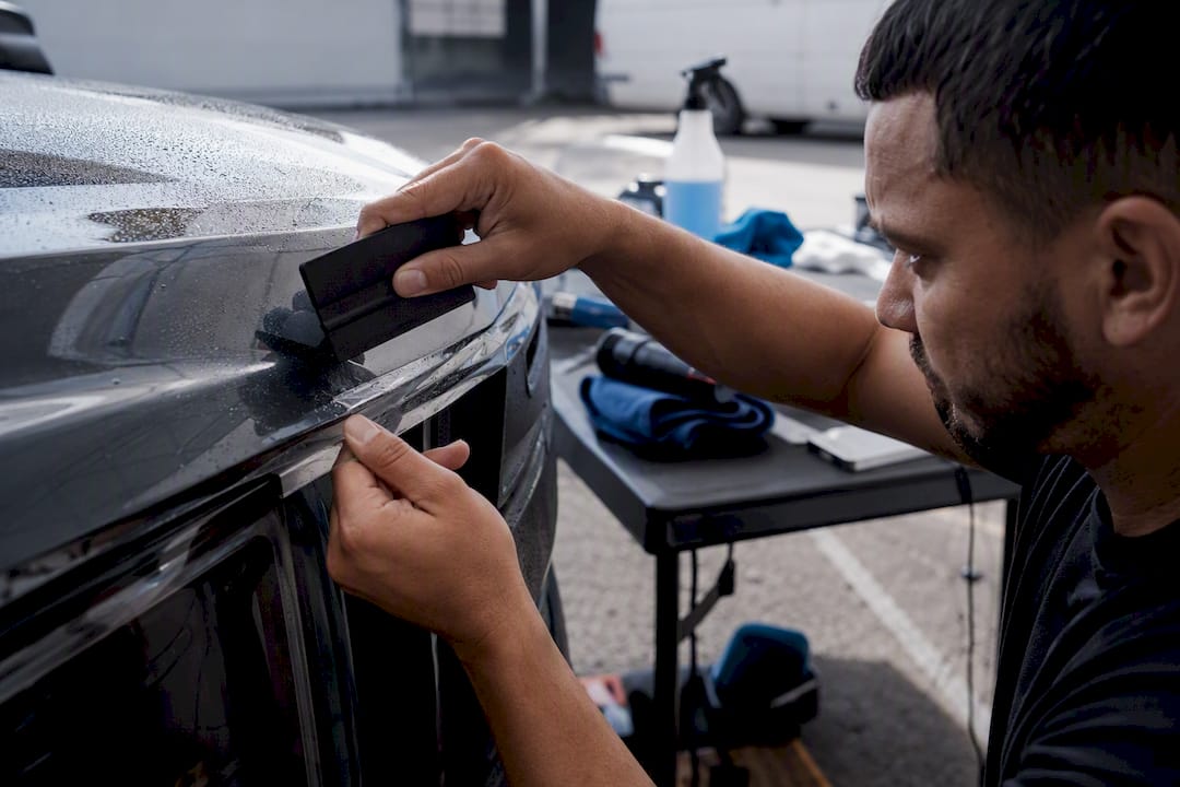 Close-up hands applying truck paint protection film