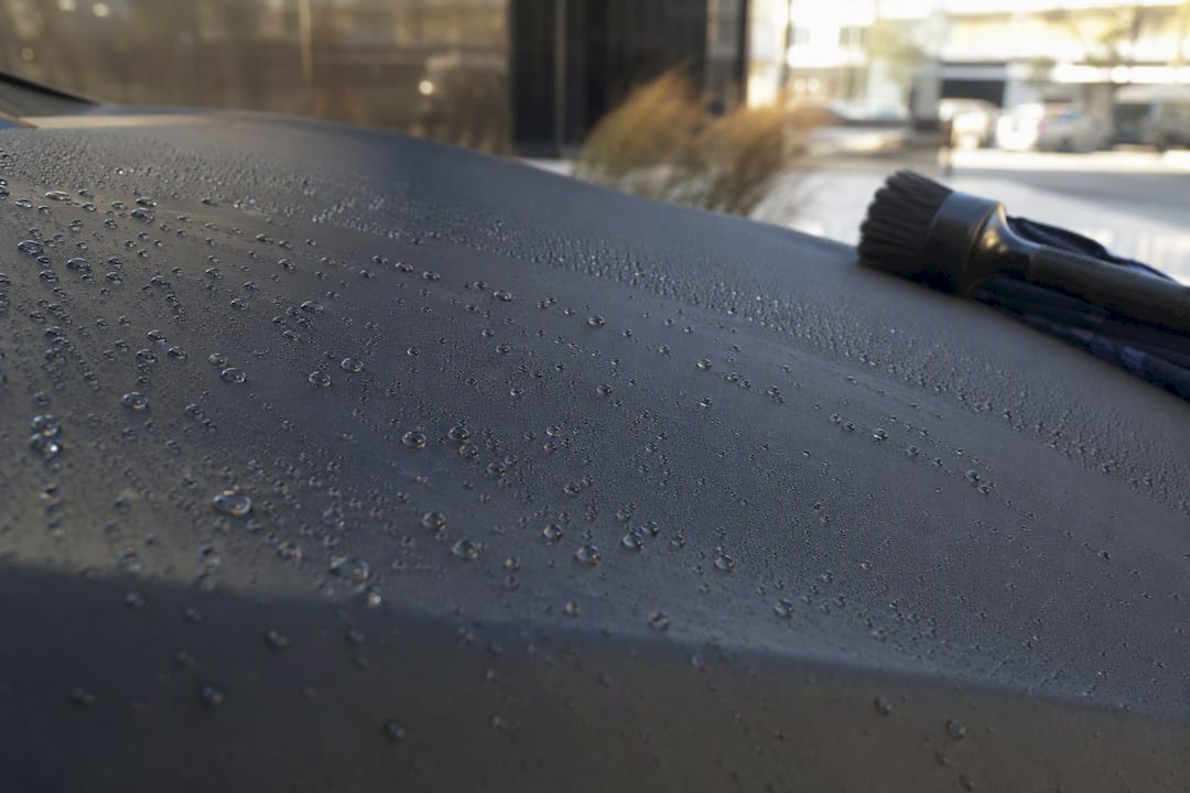 Water beading on matte paint surface