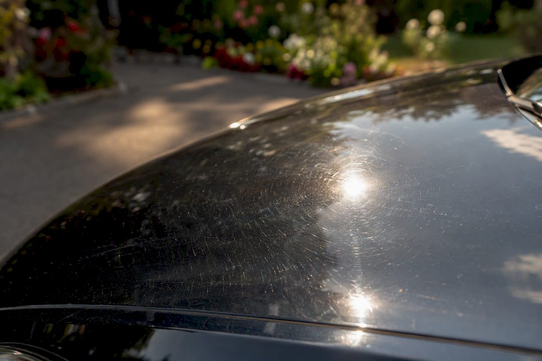 Low-angle sunlight reveals paint swirl marks
