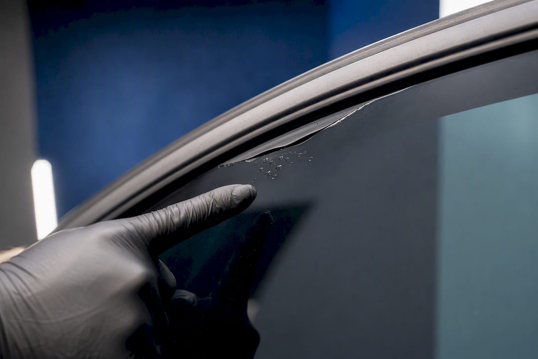 Close-up inspection of bubbled window tint film