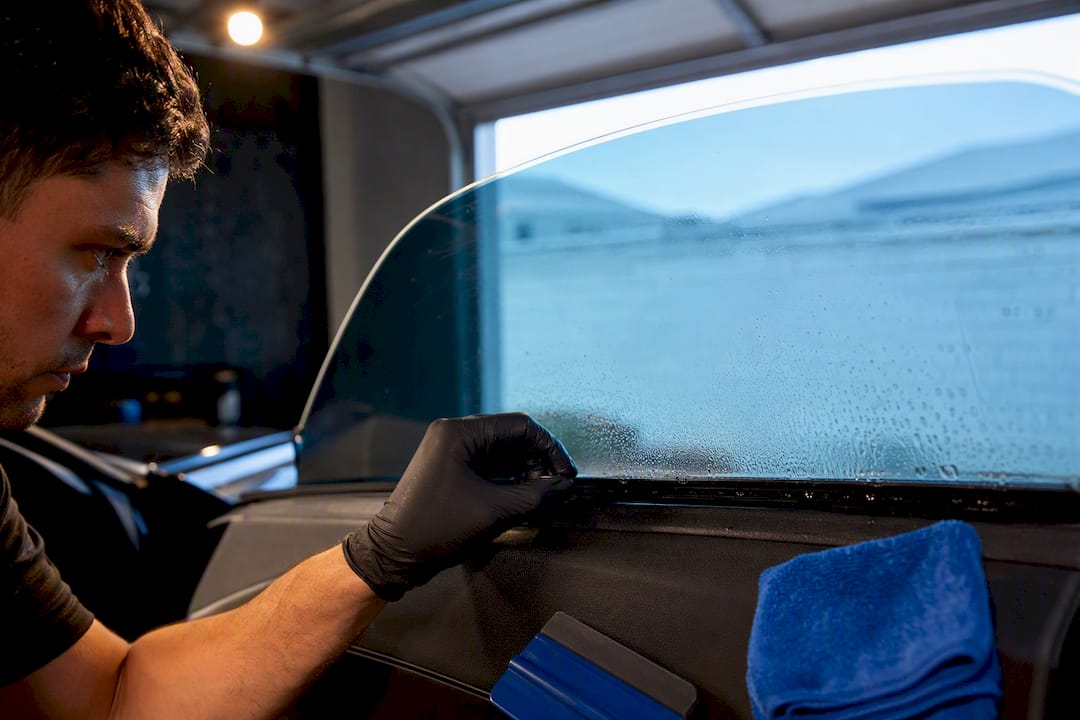 Installer checking curing window tint edge