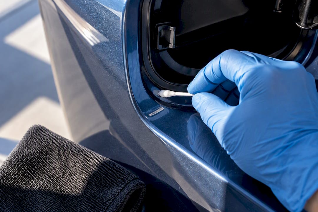 Detailer testing solvent on car paint