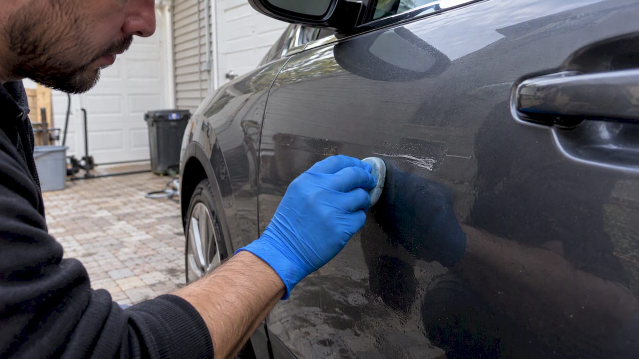 Clay bar being used on paint transfer