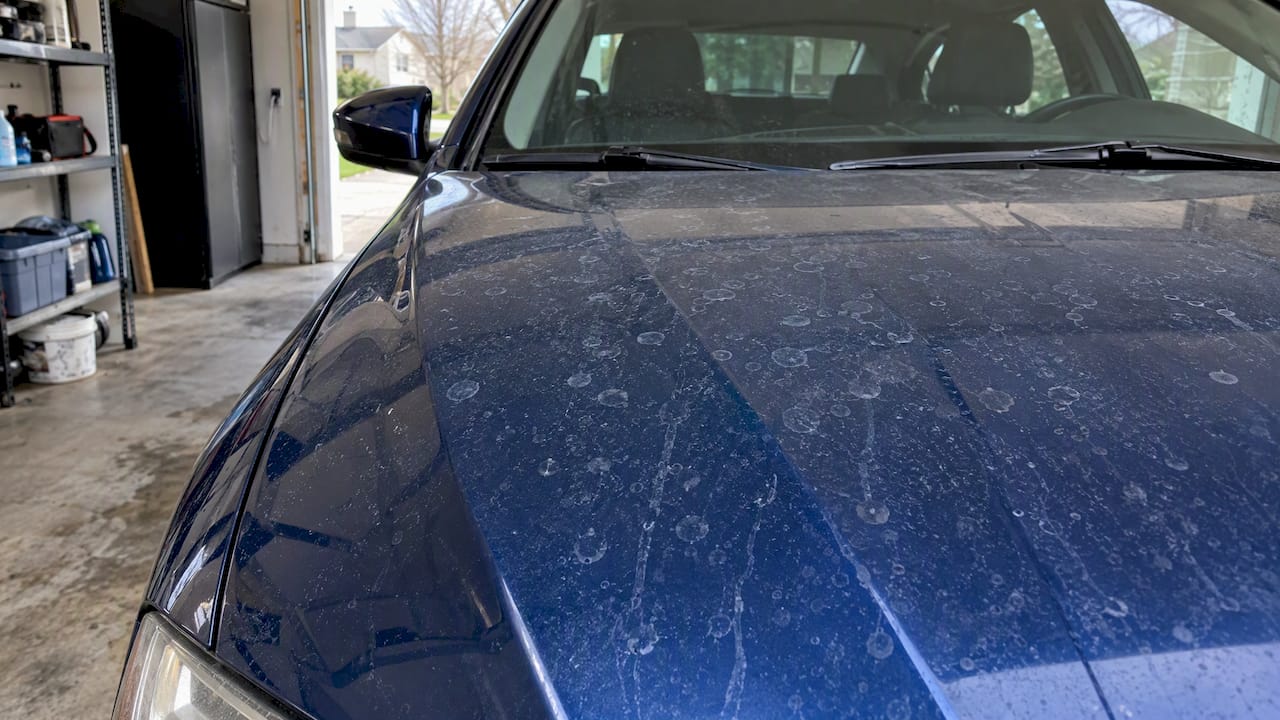 Mineral water spots dried on blue car paint