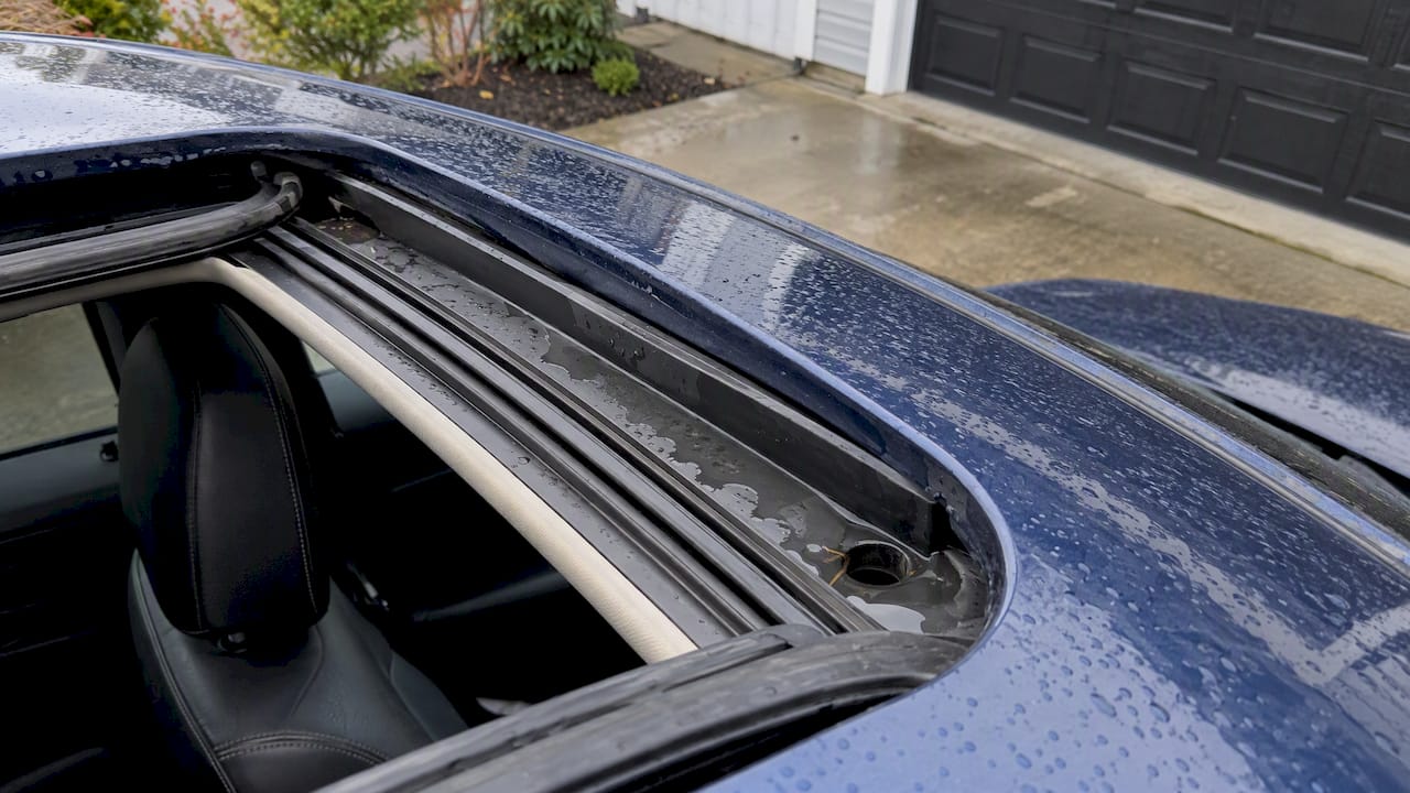 Water pooled at a sunroof drain corner